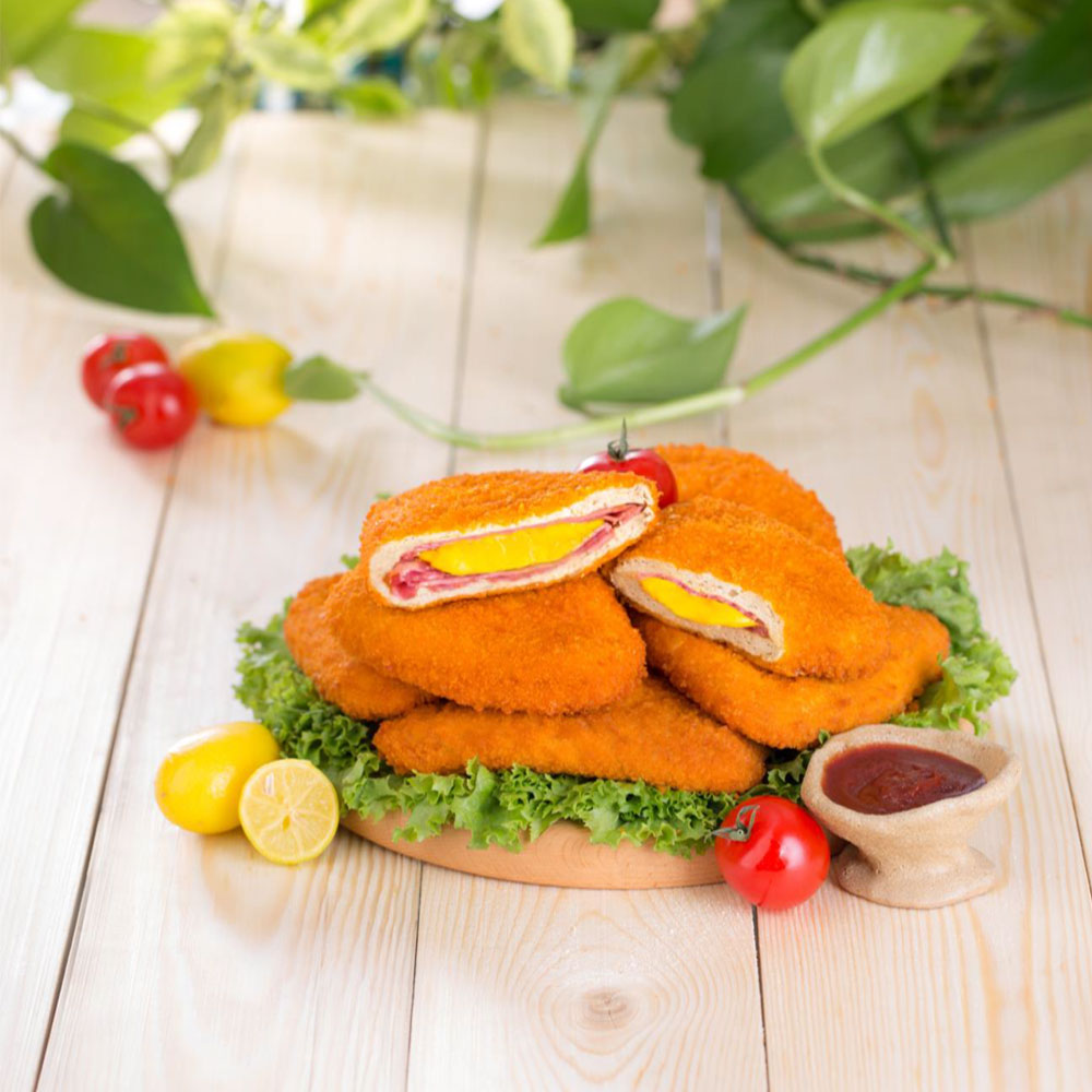 Golden crispy cordon bleu filled with chicken, cheese, and ham